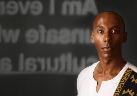 Young black man looking to camera with campaign branding